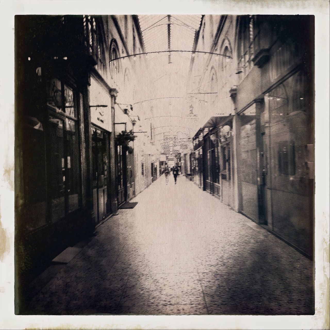 NARROW ALLEY WITH BUILDINGS IN BACKGROUND