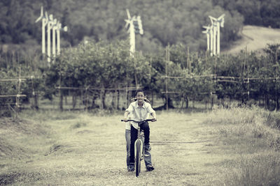 Full length of man cycling on road