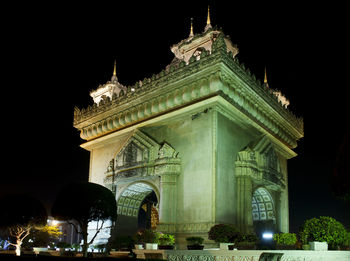 Low angle view of statue at night