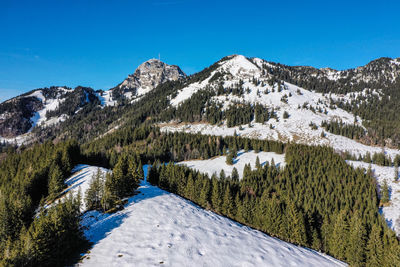 Scenic view of snowcapped mountains against clear blue sky