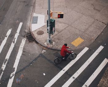 Rear view of woman standing on road