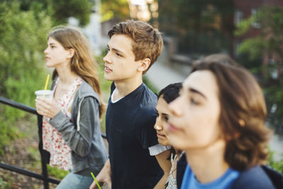 Teenagers moving up steps outdoors