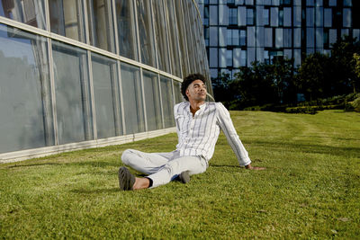 Young man sitting on field