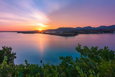 Scenic view of lake against sky during sunset