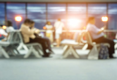 People sitting on table in illuminated room