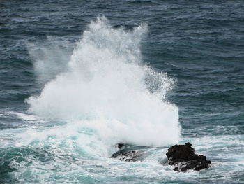 Waves breaking against sea