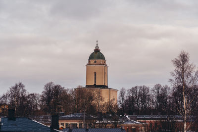 Church by building against sky