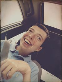 Portrait of smiling young woman in car