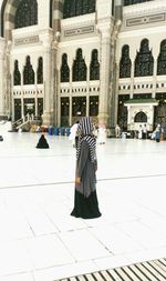 Full length of woman standing at al-haram mosque
