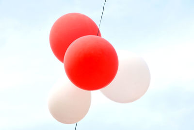 Low angle view of balloons against sky