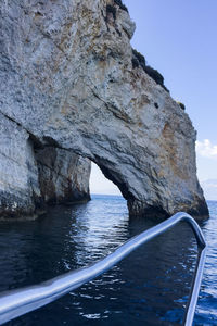 Rock formation in sea against sky