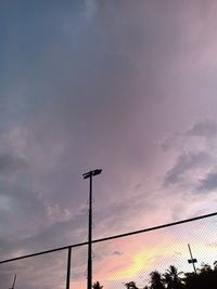 Low angle view of street light against sky during sunset