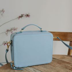 Close-up of blue purse on wooden table