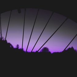 Low angle view of silhouette trees against sky