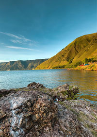 Scenic view of lake against blue sky