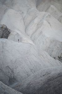 Distance view off person standing on rocky mountains