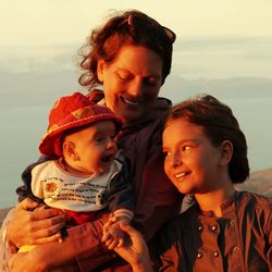 Smiling family against sky