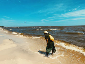 Full length of man on beach against sky