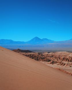 Scenic view of landscape against clear blue sky at atacama desert