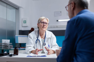 Doctor talking with patient in clinic