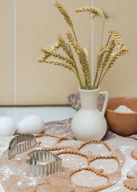 Close-up of white flowers in vase on table