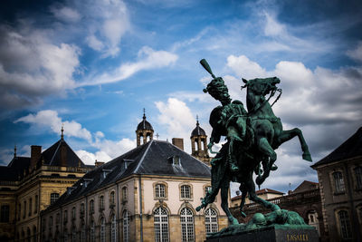 Low angle view of statue against cloudy sky