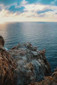 Rock formation in sea against sky