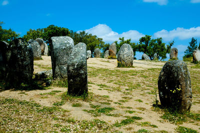 Stone structure on field against sky