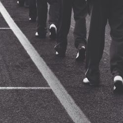 Low section of people walking on road