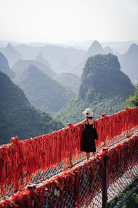 Woman standing on mountain looking at mountains