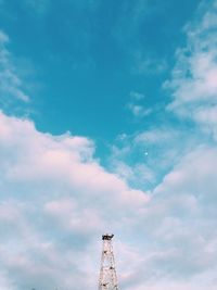 Low angle view of communications tower against sky