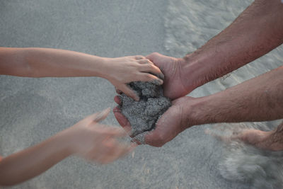 High angle view of hands on water