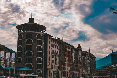 Exterior of buildings in town against cloudy sky