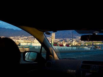 Close-up of cityscape seen through car windshield at night