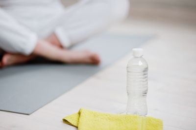 Low section of man doing yoga in studio