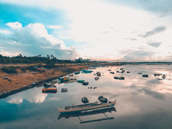 Boats in water against sky