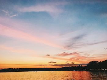 Scenic view of lake against romantic sky at sunset