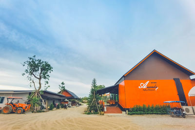 Houses on beach against sky