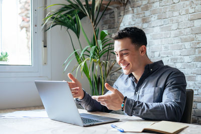 Young man using laptop at office