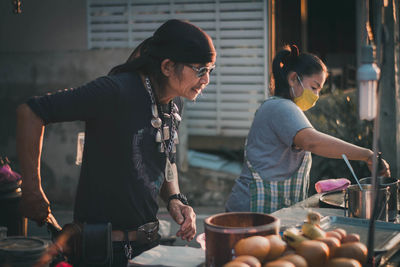 Street vendors cooking at market stall