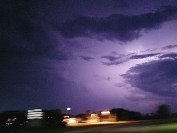 Storm clouds over city at night