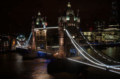 High angle view of tower bridge over river at night in city