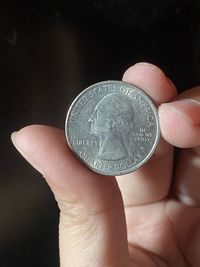 Close-up of hand holding coins