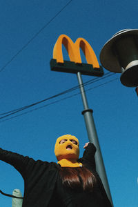 Low angle view of stuffed toy against blue sky