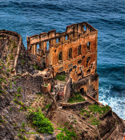 High angle view of abandoned building by sea