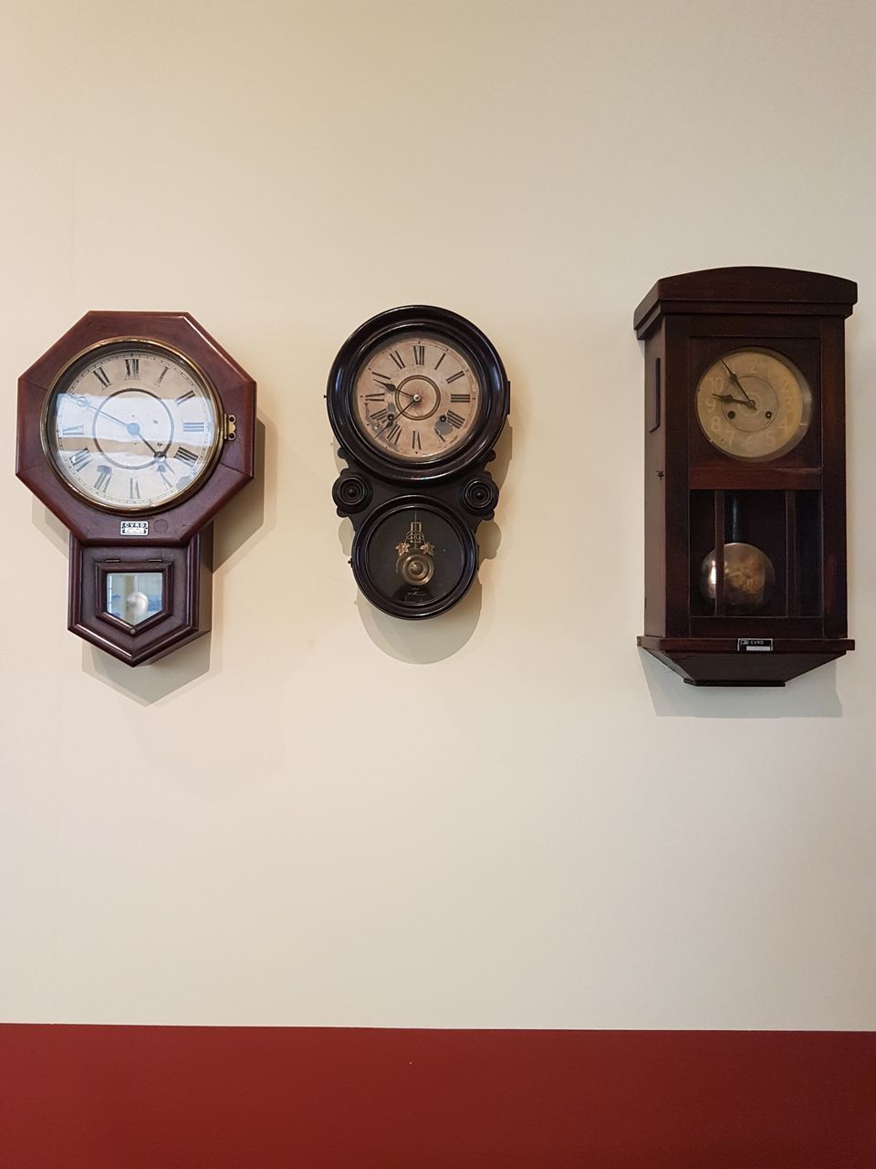 CLOSE-UP OF CLOCK AGAINST WALL