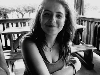 Portrait of young woman sitting on chair