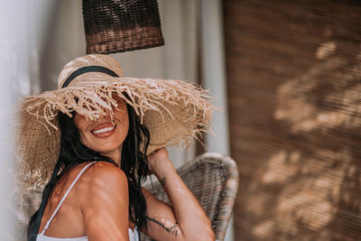 Portrait of a smiling young woman wearing hat