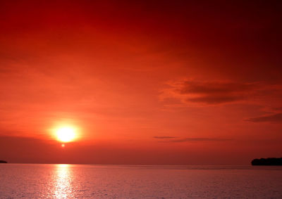 Scenic view of sea against romantic sky at sunset