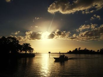 Scenic view of silhouette palm trees against sky during sunset